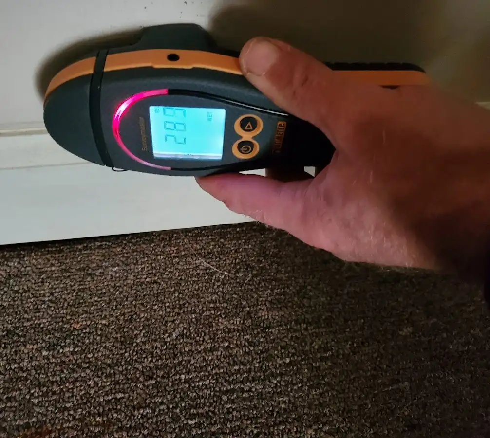 Moisture detection at baseboard during Storm Damage Restoration in Wantage